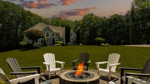 59 Sanderson Rd, Poland, ME 04274 - patio terrace at dusk with a fire pit, a yard, and a patio