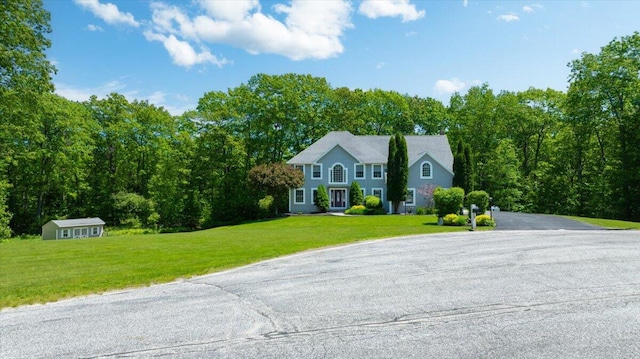 59 Sanderson Rd, Poland, ME 04274 - colonial inspired home with a front yard and an outbuilding