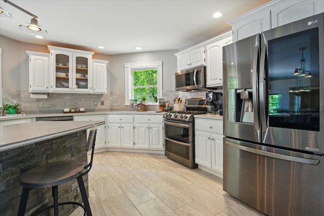 59 Sanderson Rd, Poland, ME 04274 - kitchen with appliances with stainless steel finishes, tasteful backsplash, white cabinetry, light countertops, and recessed lighting