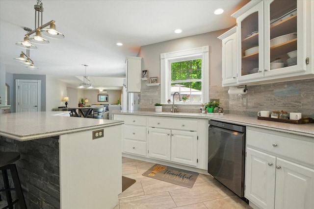 59 Sanderson Rd, Poland, ME 04274 - kitchen featuring dishwasher, a sink, a breakfast bar, decorative backsplash, and white cabinets