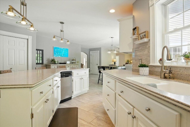 59 Sanderson Rd, Poland, ME 04274 - kitchen with a sink, decorative light fixtures, light stone countertops, a center island, and recessed lighting