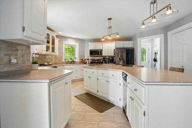 59 Sanderson Rd, Poland, ME 04274 - kitchen with appliances with stainless steel finishes, backsplash, a kitchen island, white cabinetry, and recessed lighting