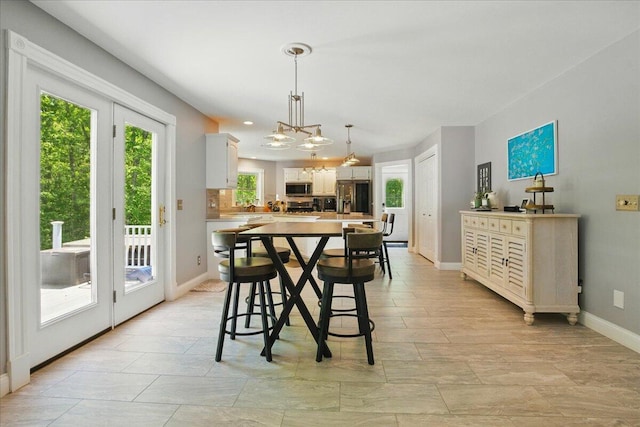 59 Sanderson Rd, Poland, ME 04274 - dining room with baseboards and a chandelier