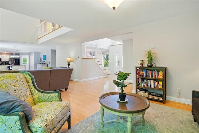59 Sanderson Rd, Poland, ME 04274 - living area featuring light wood-style flooring, stairway, and baseboards