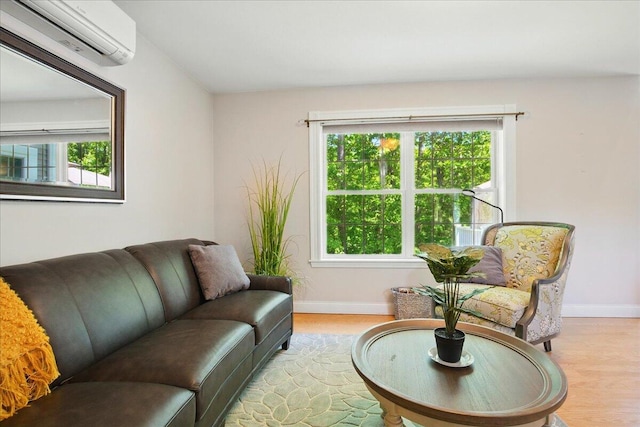 59 Sanderson Rd, Poland, ME 04274 - living room featuring an AC wall unit, baseboards, and plenty of natural light