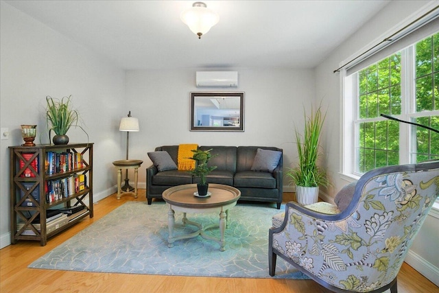 59 Sanderson Rd, Poland, ME 04274 - living room featuring a wall mounted AC, healthy amount of natural light, baseboards, and wood finished floors