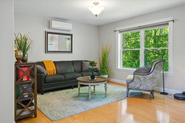 59 Sanderson Rd, Poland, ME 04274 - living area with a wall mounted air conditioner, wood finished floors, and baseboards