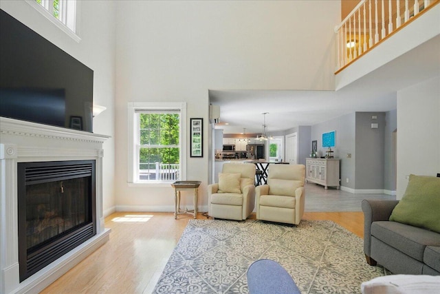 59 Sanderson Rd, Poland, ME 04274 - living room with a high ceiling, wood finished floors, plenty of natural light, and baseboards
