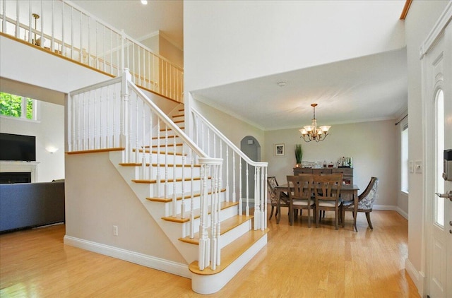 59 Sanderson Rd, Poland, ME 04274 - stairs with wood finished floors, a chandelier, baseboards, ornamental molding, and a towering ceiling