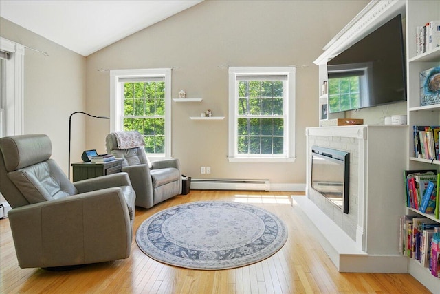 59 Sanderson Rd, Poland, ME 04274 - living room featuring a baseboard heating unit, lofted ceiling, plenty of natural light, and hardwood / wood-style floors