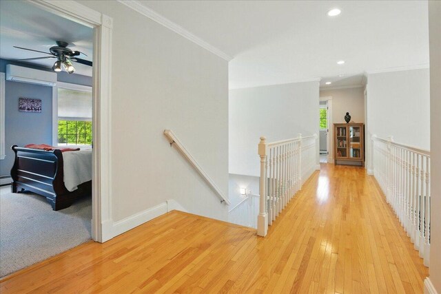 59 Sanderson Rd, Poland, ME 04274 - hallway featuring an upstairs landing, a wall mounted air conditioner, plenty of natural light, crown molding, and recessed lighting