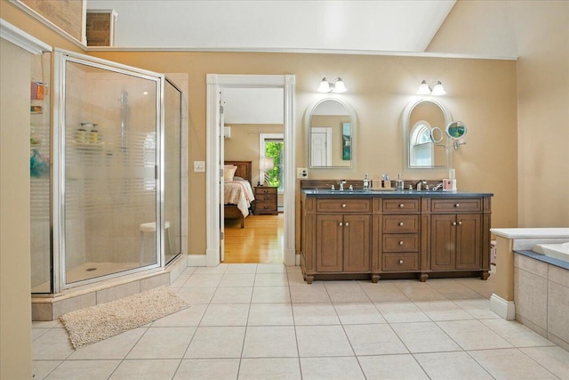 59 Sanderson Rd, Poland, ME 04274 - ensuite bathroom featuring tile patterned floors, double vanity, a shower stall, and a relaxing tiled tub