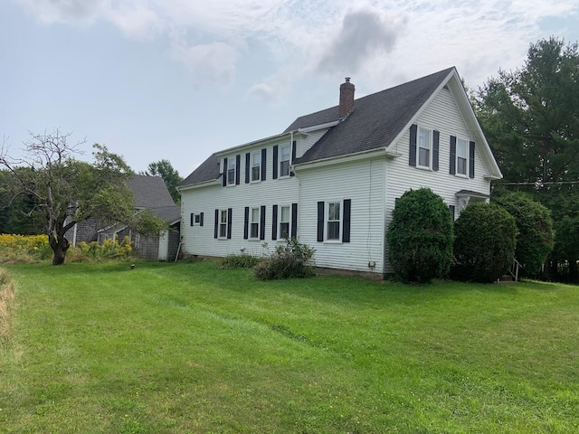 100 Bayside Rd, Ellsworth, ME 04605 - back of property featuring a chimney, a yard, and roof with shingles