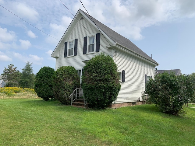 100 Bayside Rd, Ellsworth, ME 04605 - view of property exterior featuring a lawn and roof with shingles