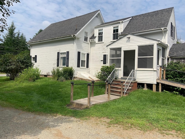 100 Bayside Rd, Ellsworth, ME 04605 - view of front of house featuring a sunroom, a shingled roof, and a front yard