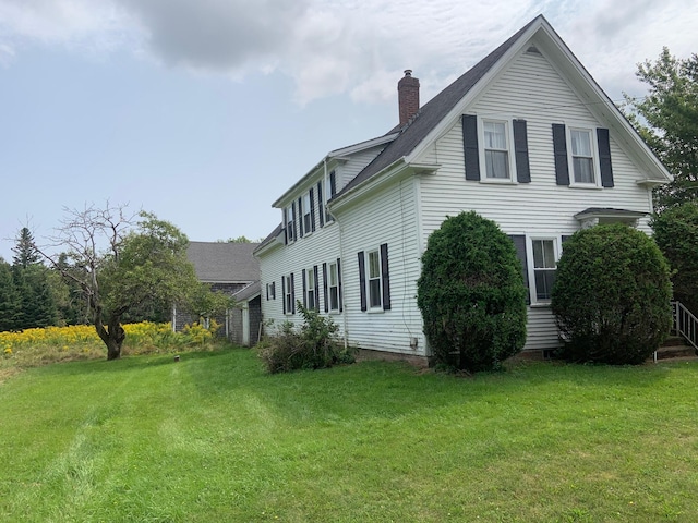 100 Bayside Rd, Ellsworth, ME 04605 - view of side of home with a chimney and a lawn