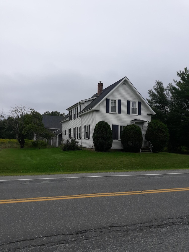 100 Bayside Rd, Ellsworth, ME 04605 - view of home's exterior featuring a chimney and a lawn