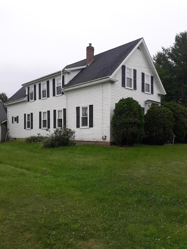 100 Bayside Rd, Ellsworth, ME 04605 - back of house featuring a chimney, a lawn, and roof with shingles