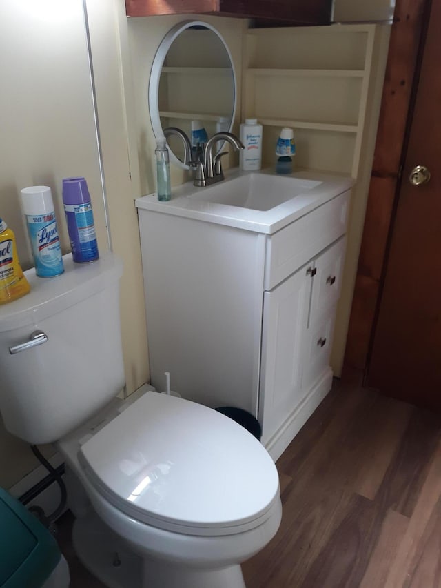100 Bayside Rd, Ellsworth, ME 04605 - half bathroom with vanity, toilet, and wood finished floors