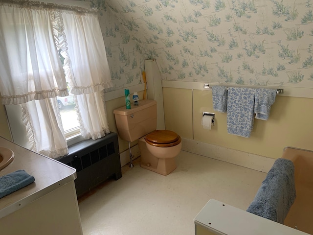 100 Bayside Rd, Ellsworth, ME 04605 - bathroom featuring wallpapered walls, radiator heating unit, toilet, and a wainscoted wall