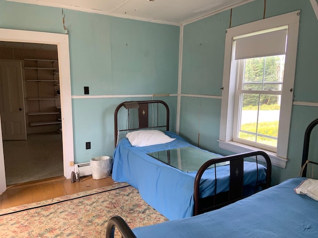 100 Bayside Rd, Ellsworth, ME 04605 - bedroom featuring hardwood / wood-style floors and a baseboard heating unit