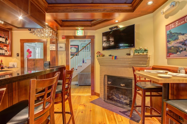 200 Shore Rd, Ogunquit, ME 03907 - indoor dry bar featuring radiator, crown molding, stairs, hardwood / wood-style floors, and a tray ceiling