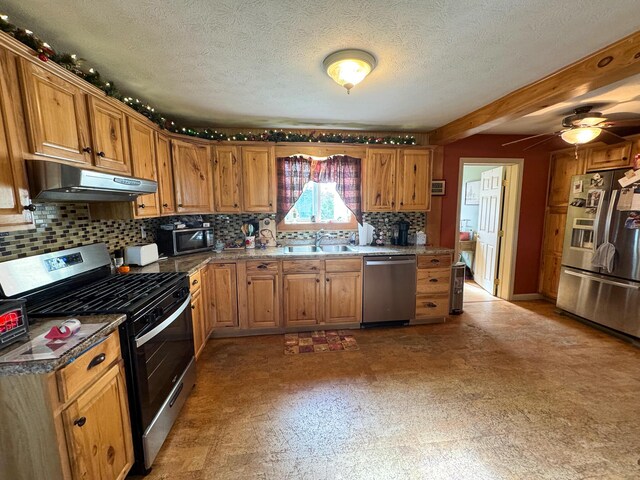 164 Mud Pond Road, Prentiss Twp T7 R3 Nbpp, ME 04487 - kitchen featuring stainless steel appliances, under cabinet range hood, backsplash, brown cabinets, and a textured ceiling