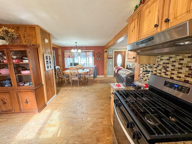 164 Mud Pond Road, Prentiss Twp T7 R3 Nbpp, ME 04487 - kitchen with under cabinet range hood, stainless steel range with gas cooktop, a chandelier, backsplash, and baseboards