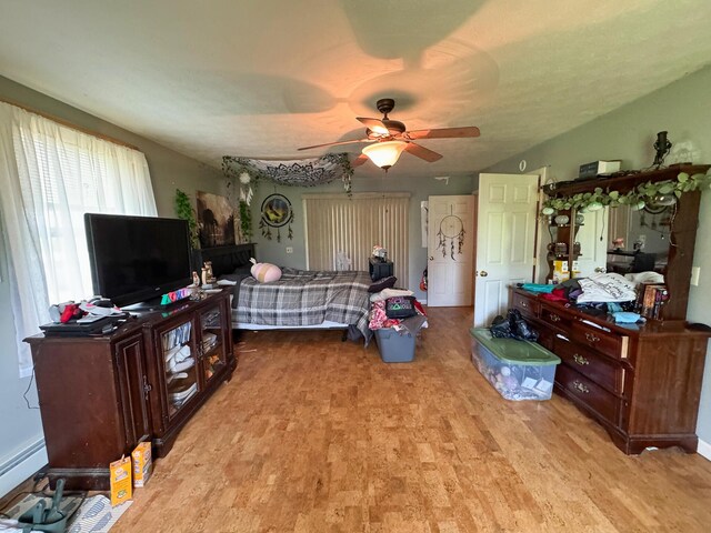 164 Mud Pond Road, Prentiss Twp T7 R3 Nbpp, ME 04487 - bedroom featuring wood finished floors, a ceiling fan, and a baseboard radiator