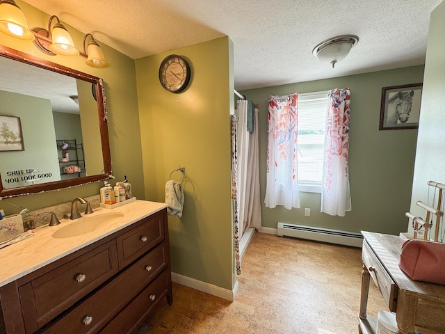 164 Mud Pond Road, Prentiss Twp T7 R3 Nbpp, ME 04487 - full bathroom with a baseboard radiator, vanity, a shower with shower curtain, a textured ceiling, and baseboards