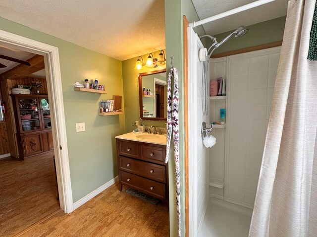164 Mud Pond Road, Prentiss Twp T7 R3 Nbpp, ME 04487 - bathroom featuring wood finished floors, curtained shower, vanity, a textured ceiling, and baseboards