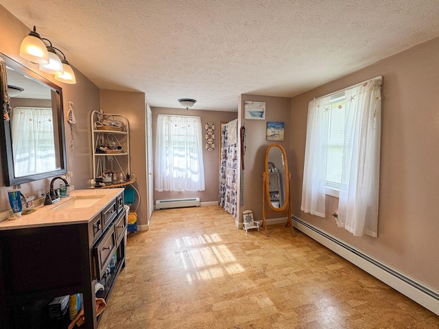 164 Mud Pond Road, Prentiss Twp T7 R3 Nbpp, ME 04487 - full bathroom featuring a baseboard heating unit, vanity, a textured ceiling, and baseboards