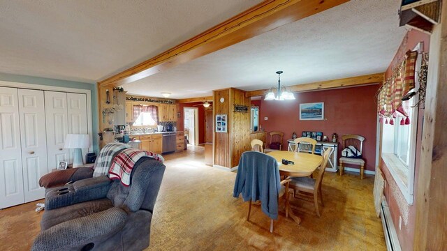 164 Mud Pond Road, Prentiss Twp T7 R3 Nbpp, ME 04487 - dining space with a chandelier, beam ceiling, a textured ceiling, baseboards, and light carpet