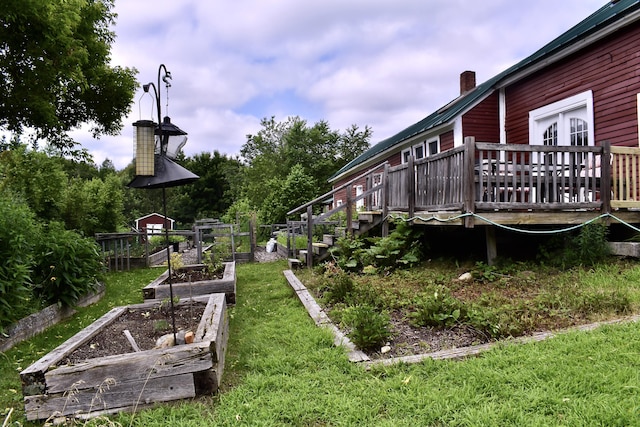 10 Rines Rd, Burnham, ME 04922 - view of green lawn with a vegetable garden and a deck