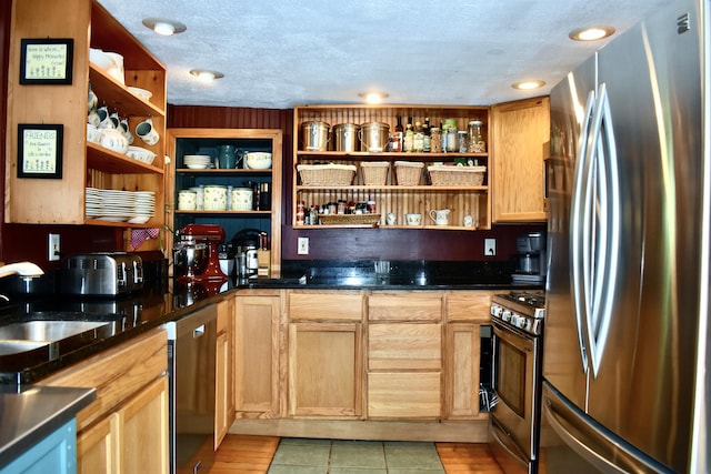 10 Rines Rd, Burnham, ME 04922 - kitchen with stainless steel appliances, open shelves, a sink, light tile patterned floors, and dark stone countertops