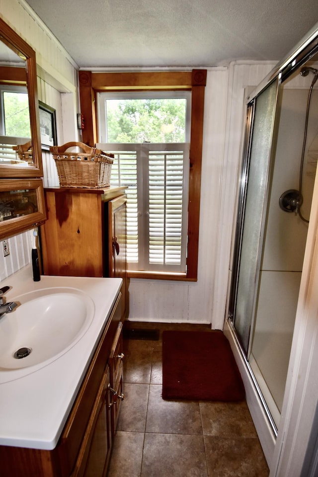 10 Rines Rd, Burnham, ME 04922 - bathroom with a shower stall, tile patterned flooring, vanity, wood walls, and ornamental molding