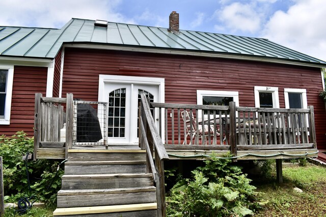 10 Rines Rd, Burnham, ME 04922 - view of exterior entry with a standing seam roof, metal roof, and a chimney