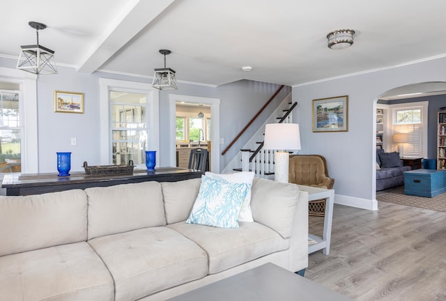 116 Hills Beach Rd, Biddeford, ME 04005 - living room with ornamental molding, stairs, wood finished floors, and arched walkways