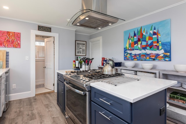 116 Hills Beach Rd, Biddeford, ME 04005 - kitchen featuring stainless steel gas range, range hood, blue cabinetry, crown molding, and light wood finished floors