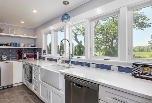 116 Hills Beach Rd, Biddeford, ME 04005 - kitchen featuring appliances with stainless steel finishes, white cabinetry, backsplash, light countertops, and pendant lighting