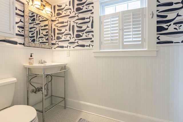116 Hills Beach Rd, Biddeford, ME 04005 - bathroom featuring a wainscoted wall, wallpapered walls, and tile patterned floors