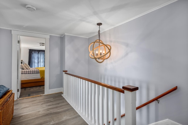 116 Hills Beach Rd, Biddeford, ME 04005 - hallway featuring a chandelier, wood finished floors, an upstairs landing, and ornamental molding