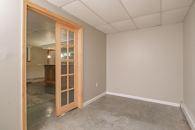 739 Spec Pond Rd, Porter, ME 04068 - spare room featuring a drop ceiling, a baseboard radiator, concrete flooring, and baseboards