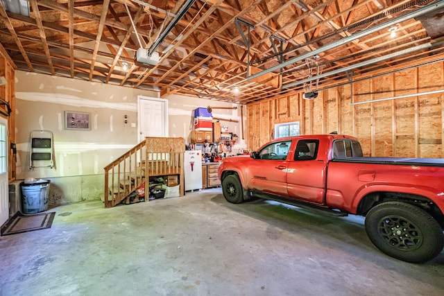 739 Spec Pond Rd, Porter, ME 04068 - garage with a garage door opener and freestanding refrigerator