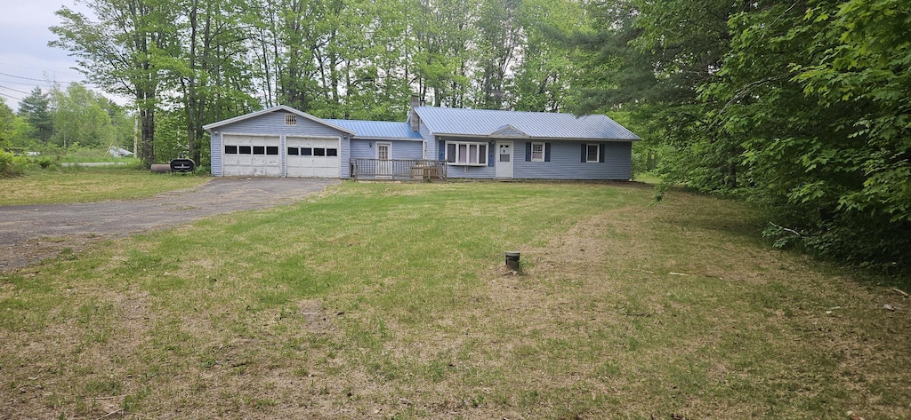2042 Athens Rd, Hartland, ME 04943 - ranch-style home with a chimney, a garage, asphalt driveway, and a front yard