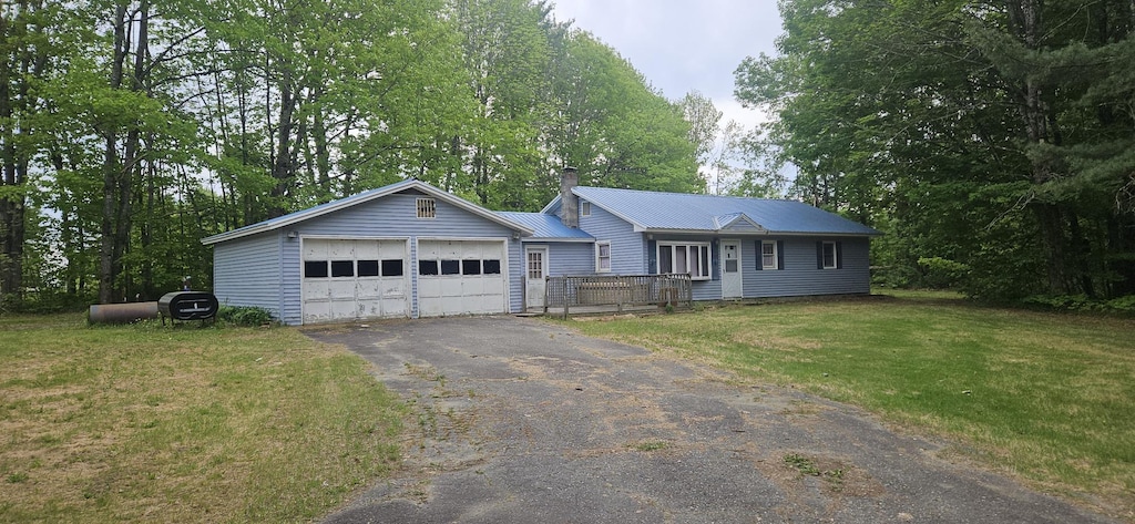 2042 Athens Rd, Hartland, ME 04943 - ranch-style home with a chimney, a front yard, metal roof, and asphalt driveway