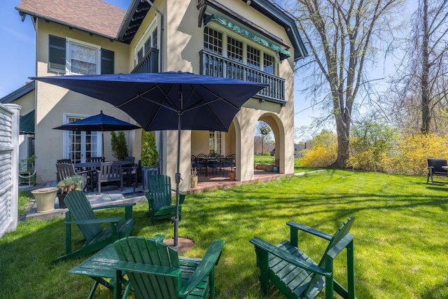 18 Bayside Dr, Belfast, ME 04915 - view of green lawn with a balcony, a patio, and outdoor dining area