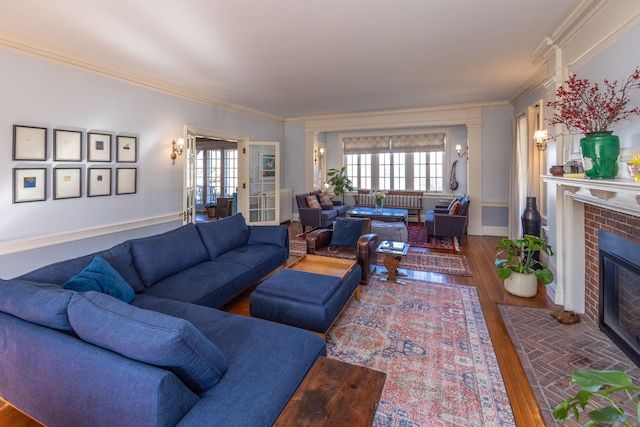 18 Bayside Dr, Belfast, ME 04915 - living area featuring wood finished floors, plenty of natural light, ornamental molding, and a brick fireplace