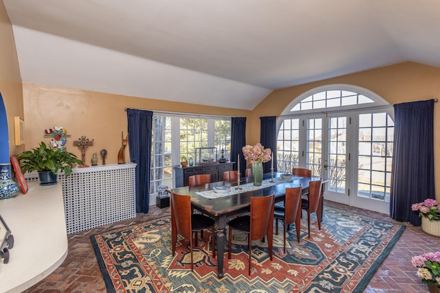 18 Bayside Dr, Belfast, ME 04915 - dining space with brick floors, lofted ceiling, french doors, and plenty of natural light