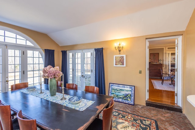 18 Bayside Dr, Belfast, ME 04915 - dining space with french doors, brick floors, lofted ceiling, and plenty of natural light